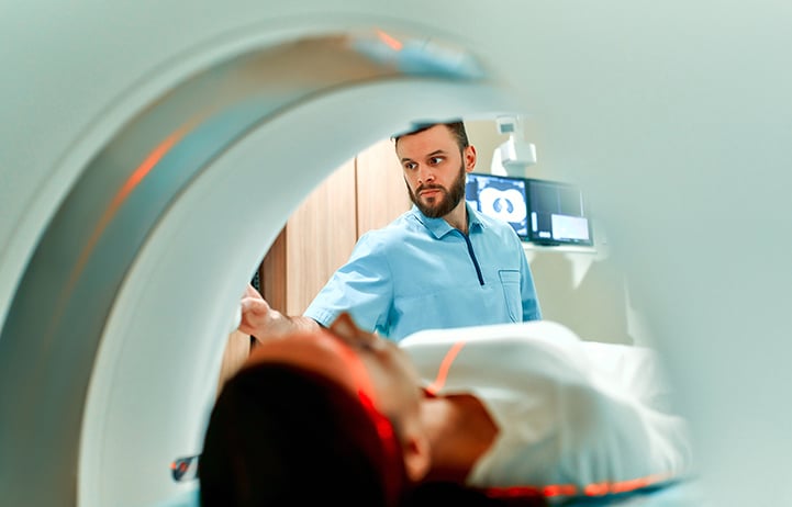 MRI Tech preforming a scan on a patient 
